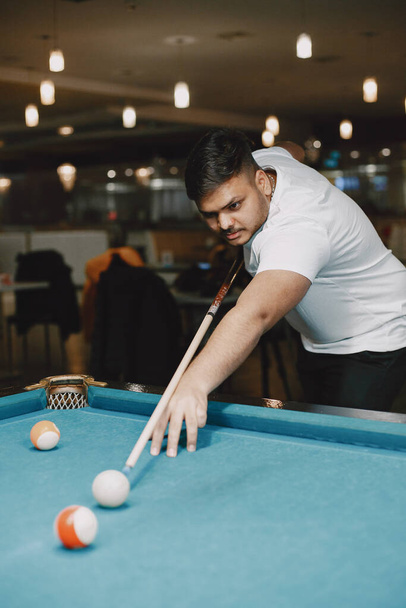 Man playing billiards in a club - Photo, image