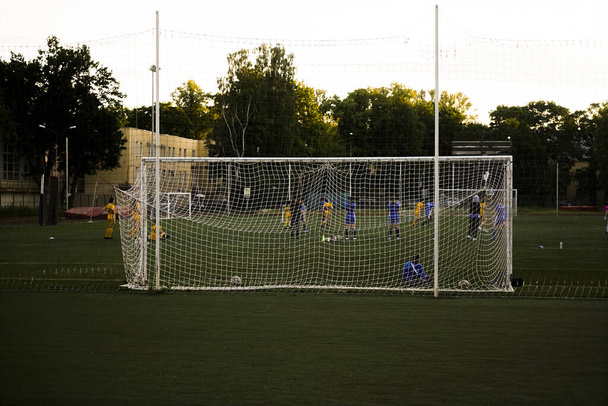team playing football . Mesh for football goal background, sport texture, women football background. - Фото, зображення