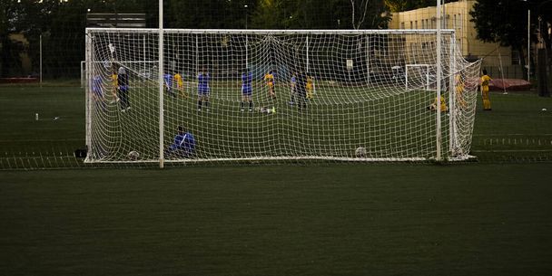 team playing football . Mesh for football goal background, sport texture, women football background. - Фото, зображення