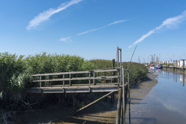 Wooden jetty at the fishing port of Spieka. Spieka is located in East Frisia on the German North Sea coast. - Φωτογραφία, εικόνα