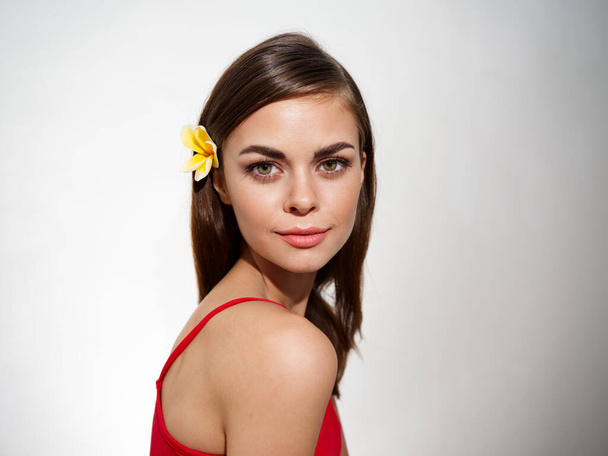 portrait of a woman with a yellow flower in her hair. High quality photo - Photo, Image