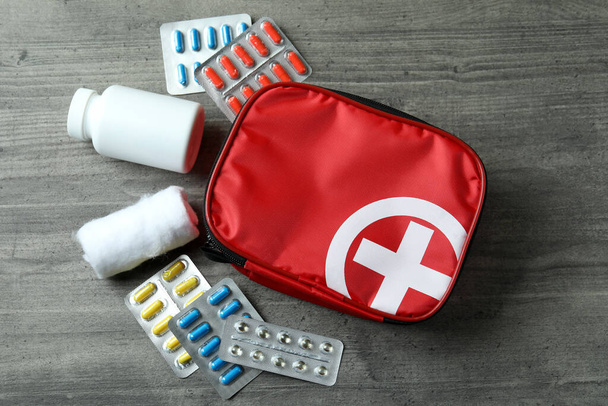 First aid medical kit on gray textured table - Fotoğraf, Görsel