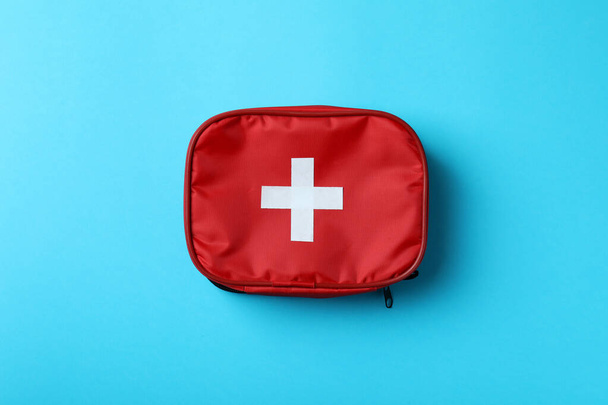 First aid medical kit on blue background - Фото, зображення