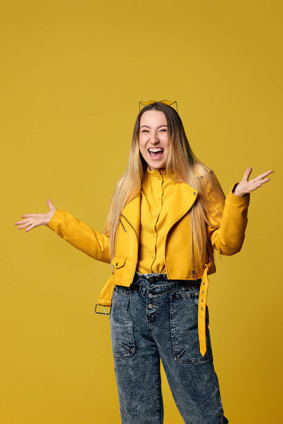 happy woman screaming on yellow background. Human emotions - 写真・画像