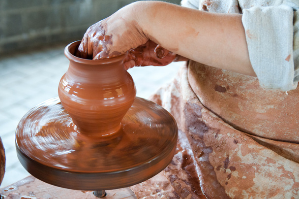 Potter making the pot in traditional style. Close up view - Photo, Image