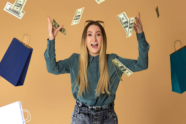 woman holds cash money under dollars rain. - Fotoğraf, Görsel