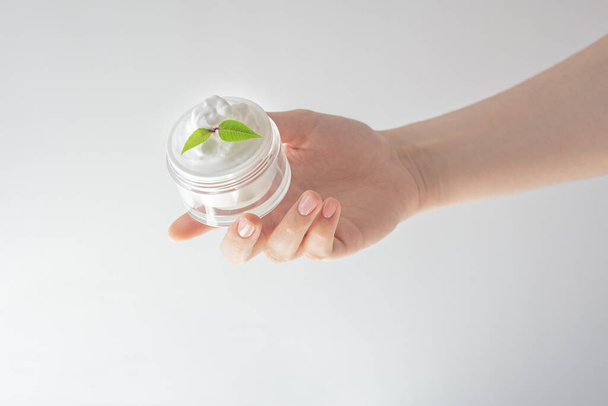 cosmetic cream, female hand, skin care, white background, female spa treatments, natural composition - Photo, Image