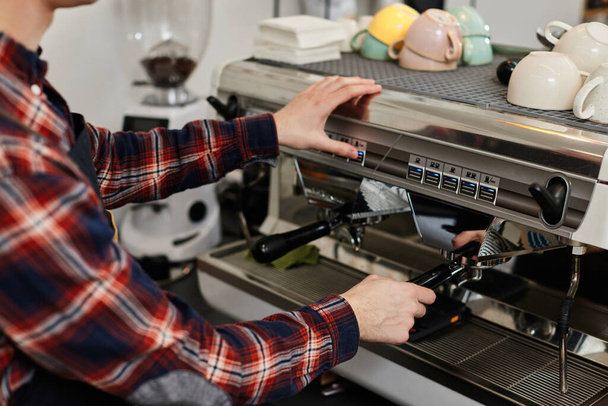 Barista using a coffee machine to make coffee - Foto, immagini