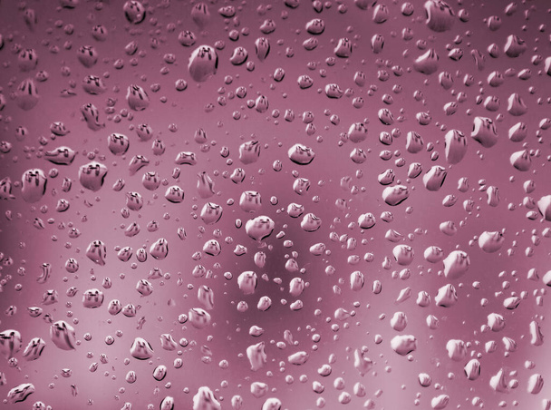 Közelkép a vízcseppek rózsaszín tónusú háttér.  - Fotó, kép