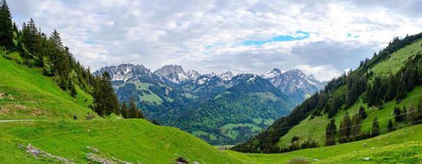 View on alps mountains, cloudy sky, green fields by Jaun. Canton Fribourg, Freiburg nearby Bulle, Bern, Thun. Good hiking tourist way. Switzerland - Φωτογραφία, εικόνα