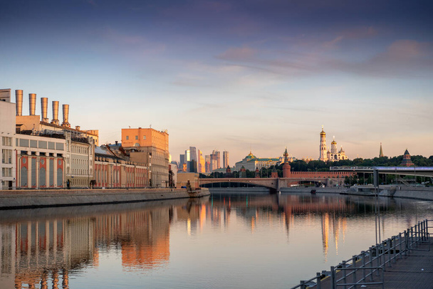 View of the Moscow Kremlin with its towers and cathedrals and reflections on the Moscow River - Photo, Image
