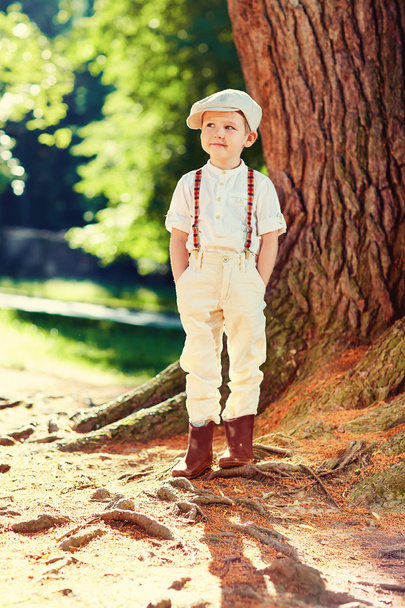 cute boy near old tree in retro clothes - Valokuva, kuva