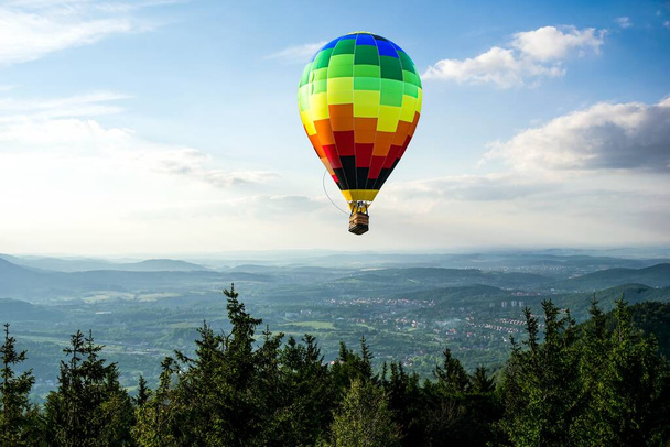  balloon soars beautifully in the air , mountains from flight altitude - Φωτογραφία, εικόνα