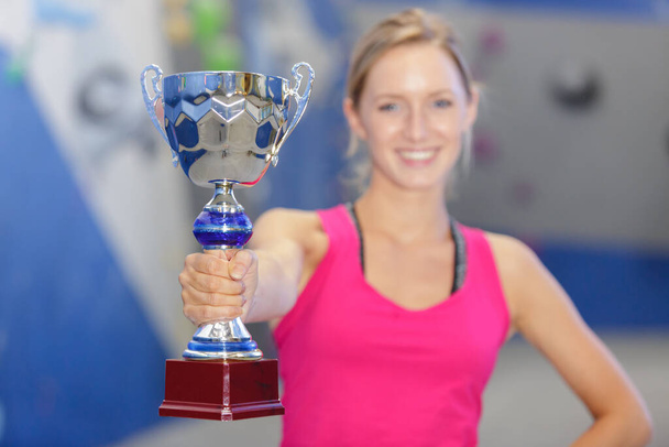 gorgeous blonde young woman holding a trophy - Fotó, kép