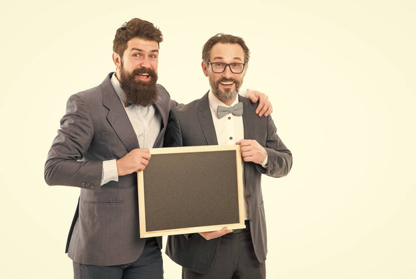Day meeting. formal businessmen, copy space. welcome on board. partners celebrate start up business isolated on white. announcement. party invitation. bearded men hold advertisement blackboard - Φωτογραφία, εικόνα