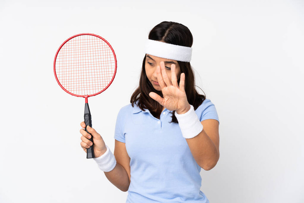 Young badminton player woman over isolated white background focusing face. Framing symbol - Photo, image
