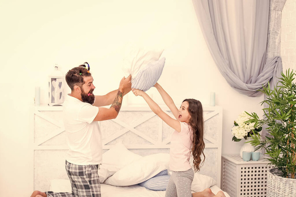 girl daughter and father playing and fighting with pillows having fun together, family happiness - Fotó, kép