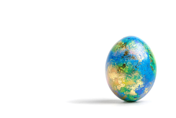 Easter eggs. Easter background. Easter. Copy cpase egg isolated on a white background painted like planet earth, a workpiece for the designer. - Zdjęcie, obraz