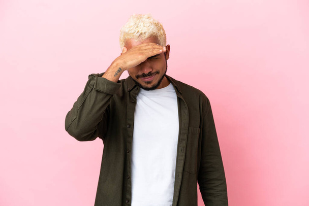 Young Colombian handsome man isolated on pink background with headache - Φωτογραφία, εικόνα