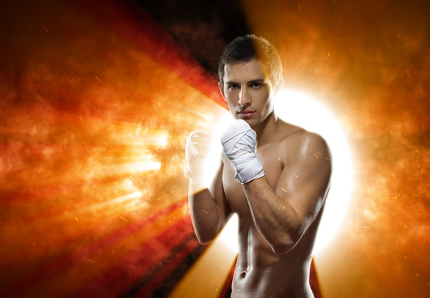 Half-length portrait of fighter against exploding sun - Foto, imagen