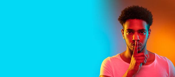 Portrait of a young african man at studio. Fashion male model in colorful bright neon lights. - Fotografie, Obrázek