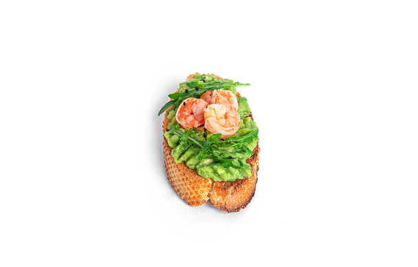 Sandwich with guacamole, shrimps, arugula, tomatoes, cucumber isolated on a white background. Bruschetta with avocado. Healthy breakfast. - Photo, Image