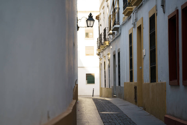 A narrow cobblestone road through the buildings - Fotó, kép