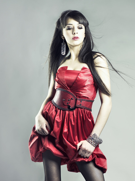 Portrait of a beautiful young lady in a red dress - Фото, зображення
