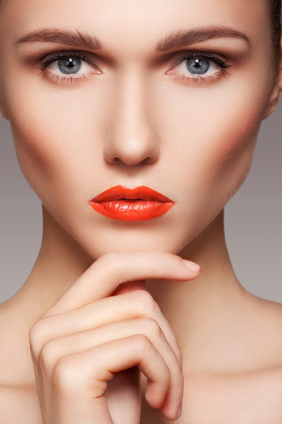 Portrait of beautiful woman's purity face with bright red lips make-up. Cute model with clean shiny skin - Foto, afbeelding