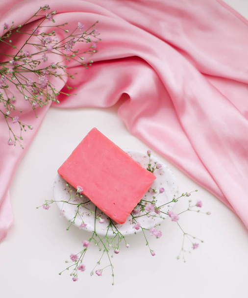 Romantic composition with a pink soap with ceramic dish and silver dress.  - Zdjęcie, obraz