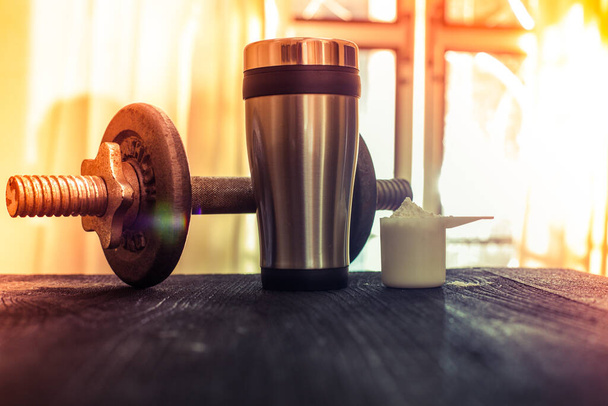 Whey protein shaker and dumbbells - Photo, Image