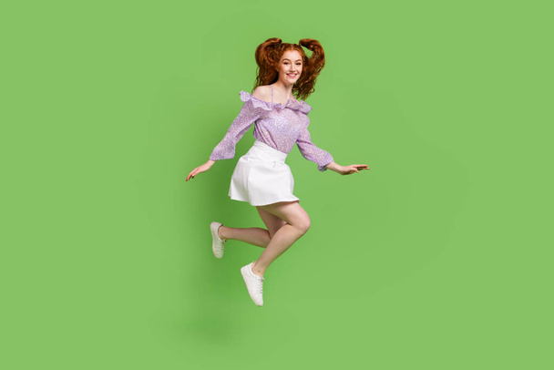 Full body profile photo of cute red hairstyle young lady jump wear blouse skirt isolated on green color background - Φωτογραφία, εικόνα