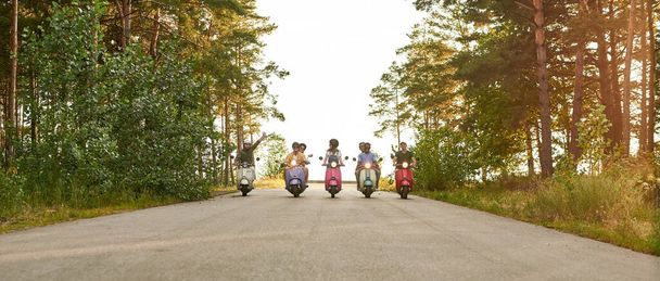 Company of young friends riding on scooter motorbikes - Fotografie, Obrázek