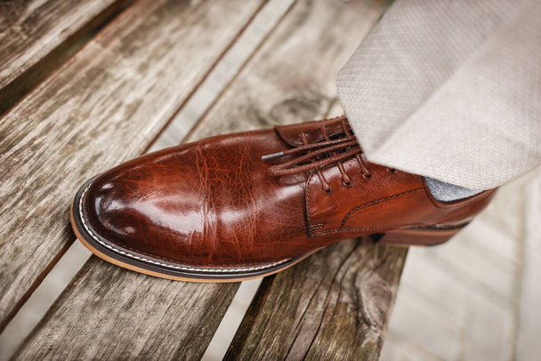 Men's brown shoes made of genuine glossy leather. - 写真・画像