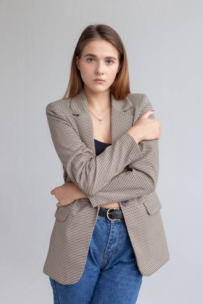 young attractive caucasian woman with long brown hair in suit jacket at studio - Foto, imagen