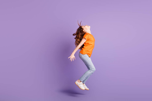 Full length body size view of attractive spprty girl jumping having fun dancing isolated over violet purple color background - Photo, Image