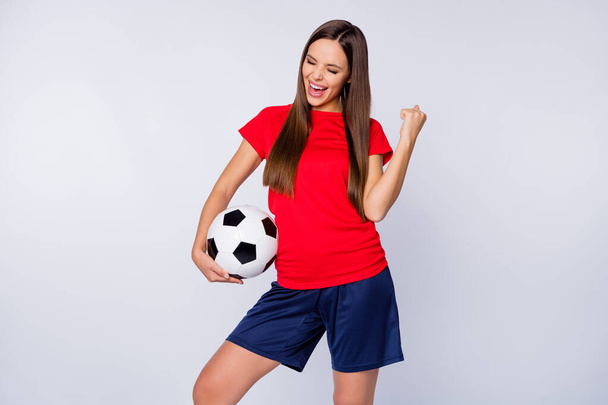 Goal Photo of excited joyful lady soccer team supporter euro 2020 hold leather ball raise fist wear spain team national football uniform t-shirt shorts isolated white color background - Fotoğraf, Görsel