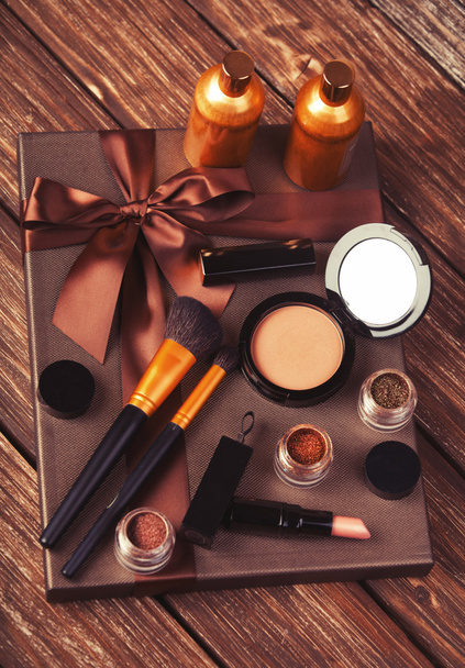 Cosmetics and gift box on wooden table. - Photo, Image