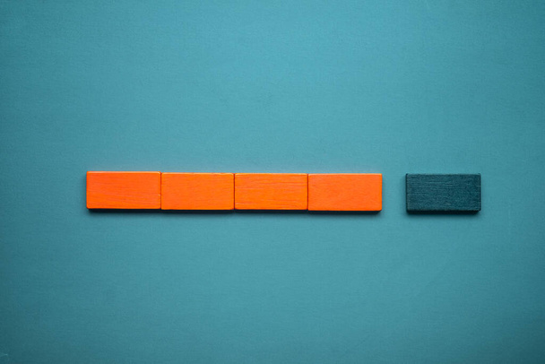 Orange sticks block lying in row connect to black sticks block. Top view - Valokuva, kuva