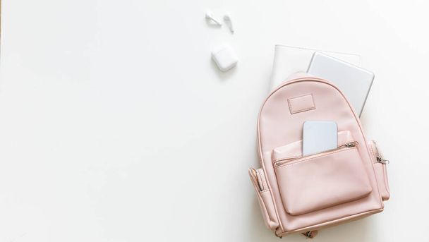 Top view elegant pink student backpack full of supplies isolated. Back to school concept - Фото, изображение