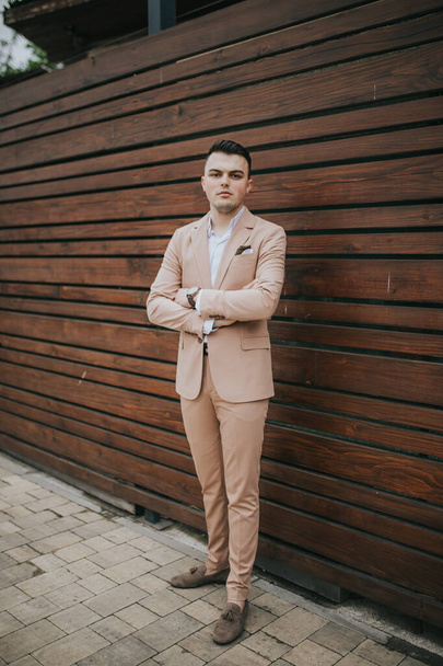 A vertical shot of a young handsome Caucasian male wearing a nice elegant suit - Фото, зображення