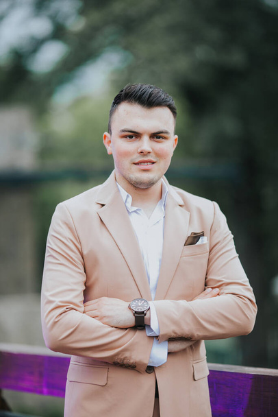 A caucasian young businessman in a suit standing outdoor - Fotó, kép