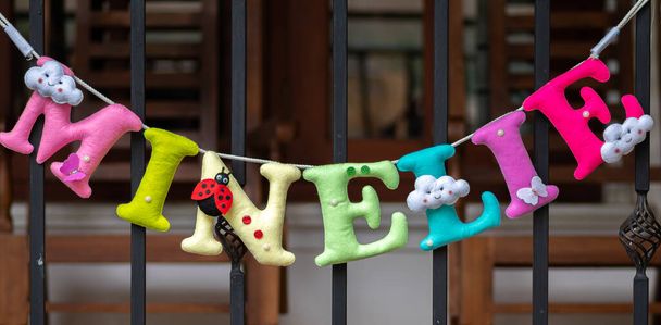 3d Plush letters name banner for a birthday party, decoration hanging in a white wall. - Photo, Image
