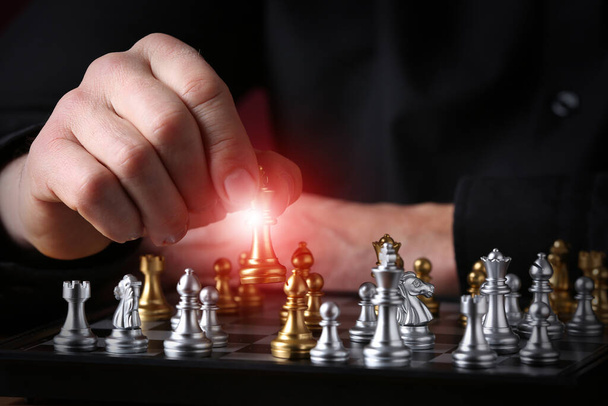 Man playing chess on dark background - Photo, Image