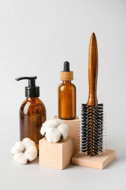 Hair brush and cosmetics on light background - Photo, Image