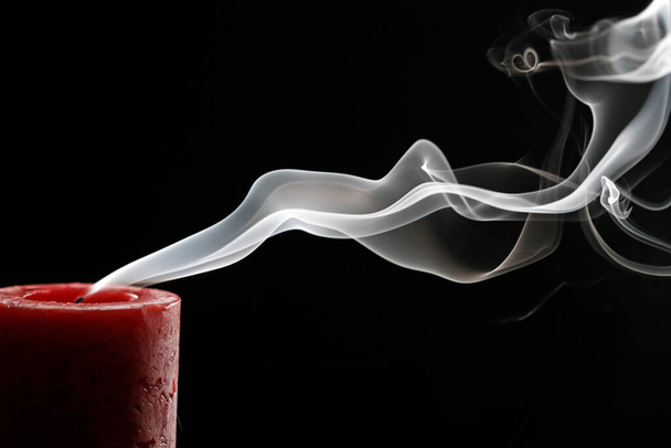 Curling smoke from one extinguished advent candle on black background.  France.  - Foto, Imagem