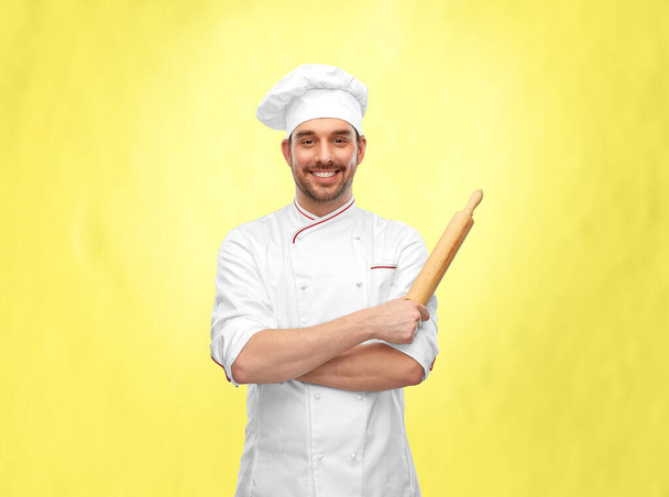 happy smiling male chef or baker with rolling pin - Photo, image