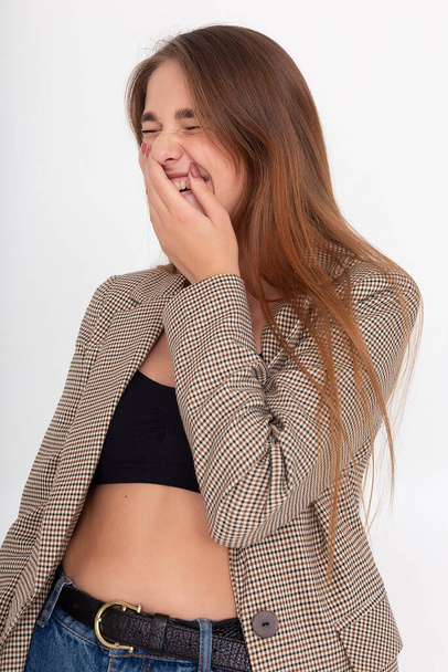 young laughing caucasian woman with long brown hair in suit jacket at studio - Photo, Image