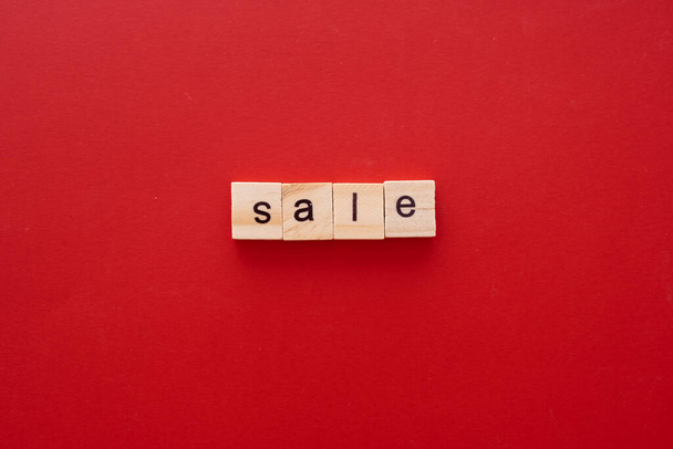 word SALE made of wooden letters on red background with copy space - Fotoğraf, Görsel