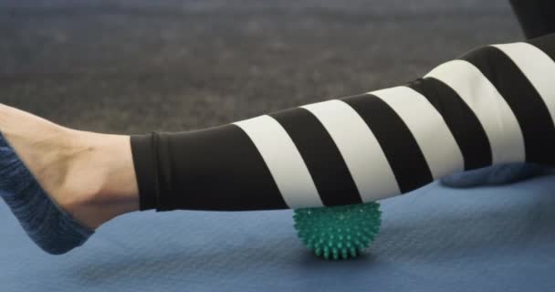 Calf fascia massage with ball for MFR. Roller to roll out calf muscles. Myofascial release. - Footage, Video